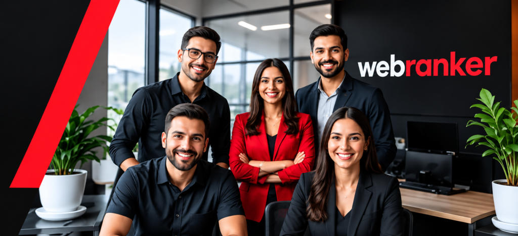 Group of five smiling professionals posing in a modern office with the 'webranker' logo on a dark wall behind them.